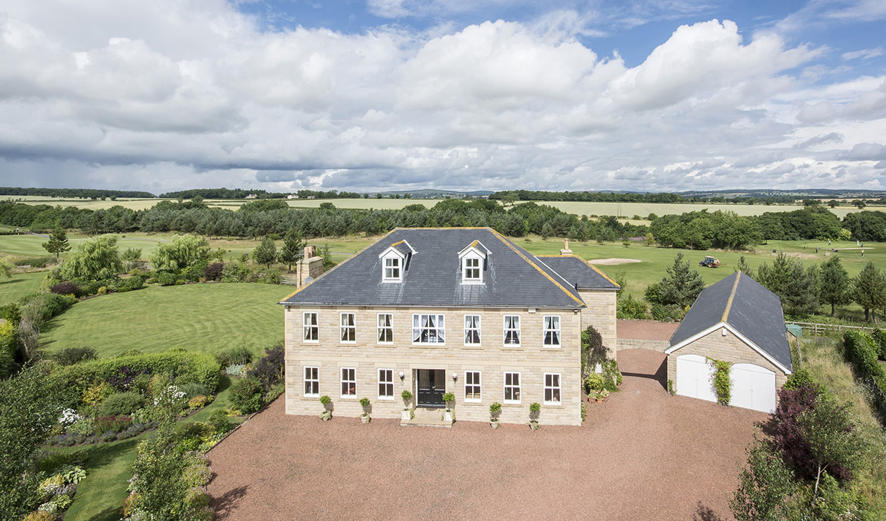 Residential property taken from a mast showing gardens and setting