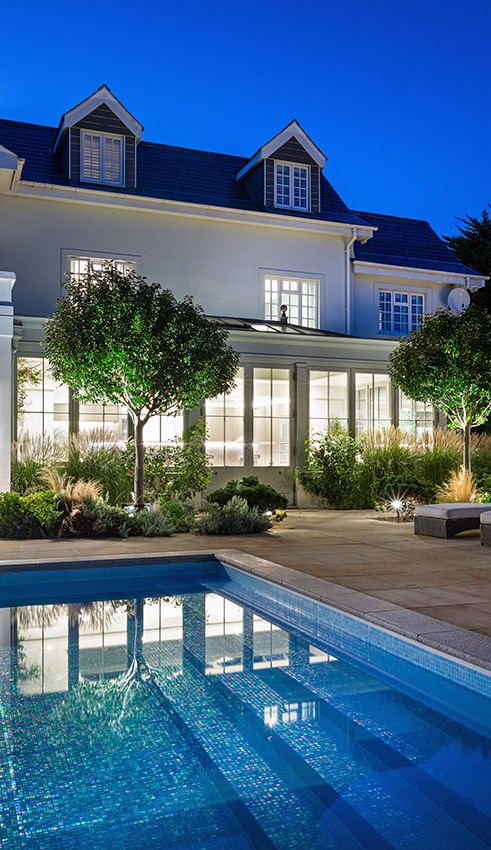 Orangery and pool at a residential property taken at dusk