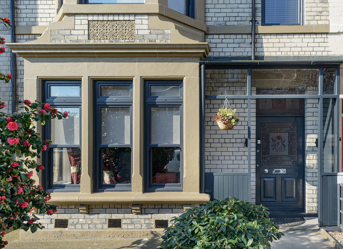 Stone bay window and front door detail on a residential property