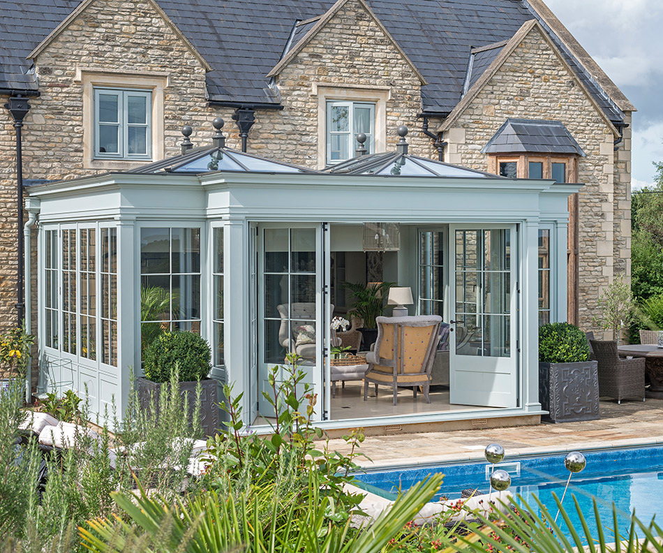 Orangery on a residential property in summer looking through garden area