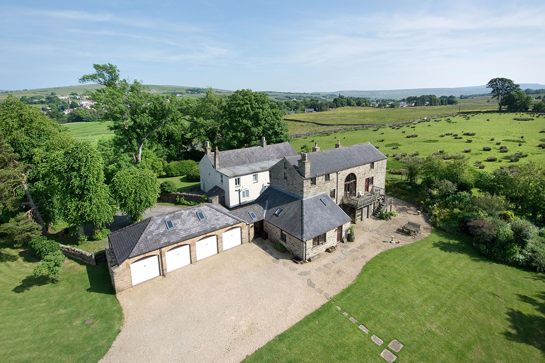 Elevated architectural exterior of a property and land