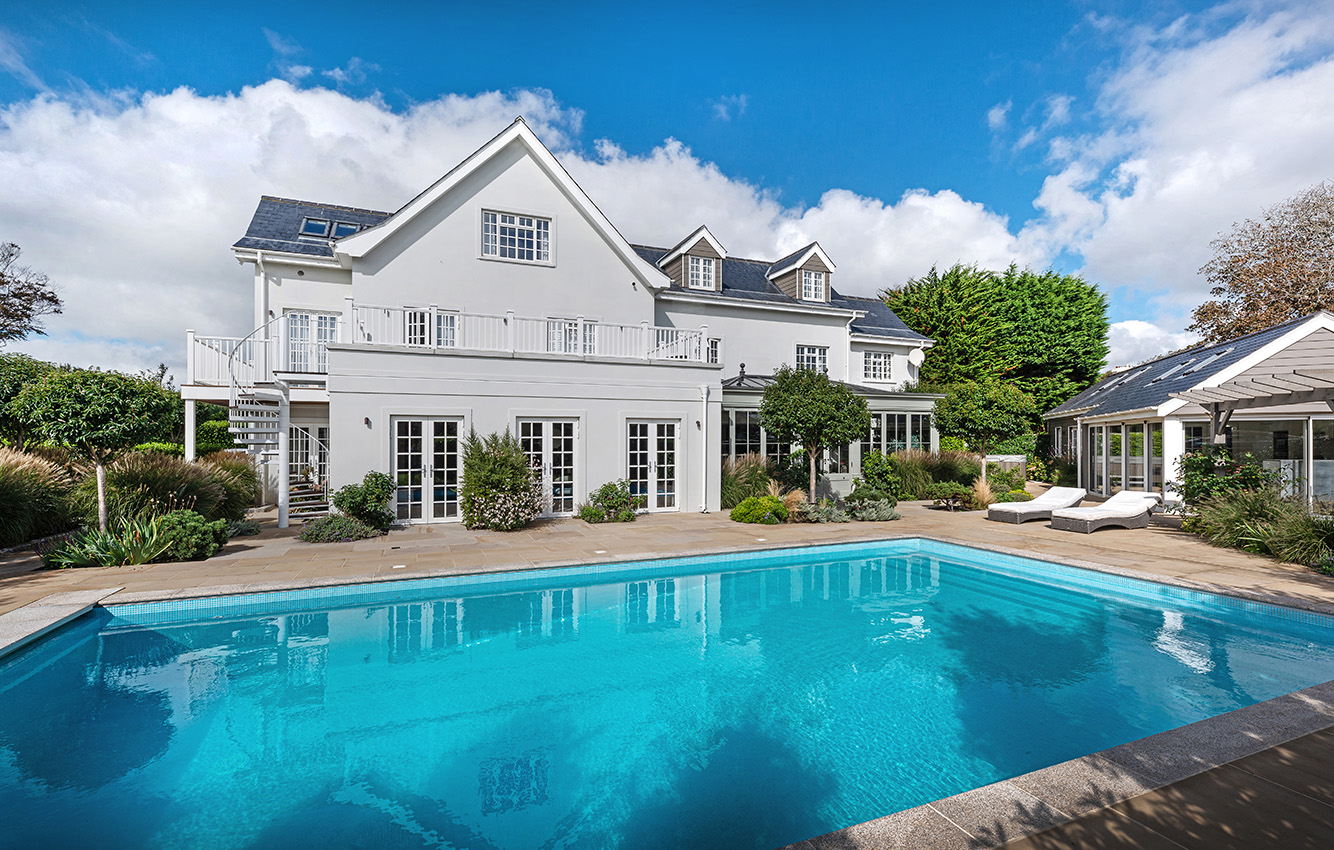 Residential property with orengery taken in summer overlooking a pool