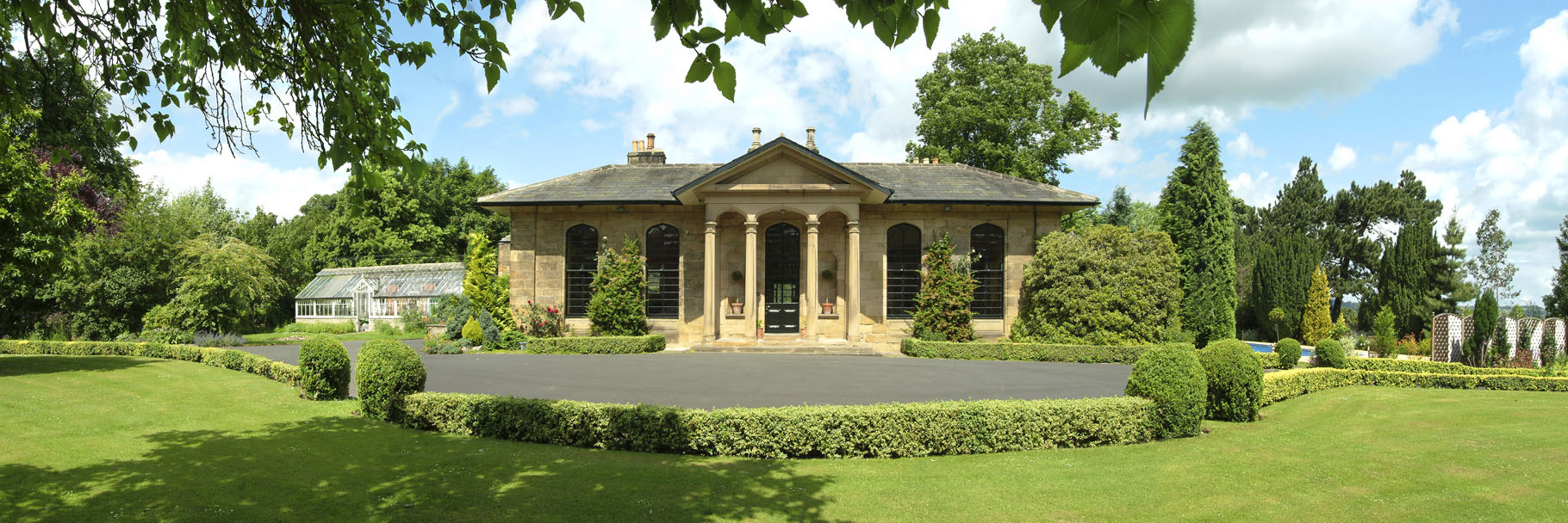 Architectural exterior of a residential property with gardens