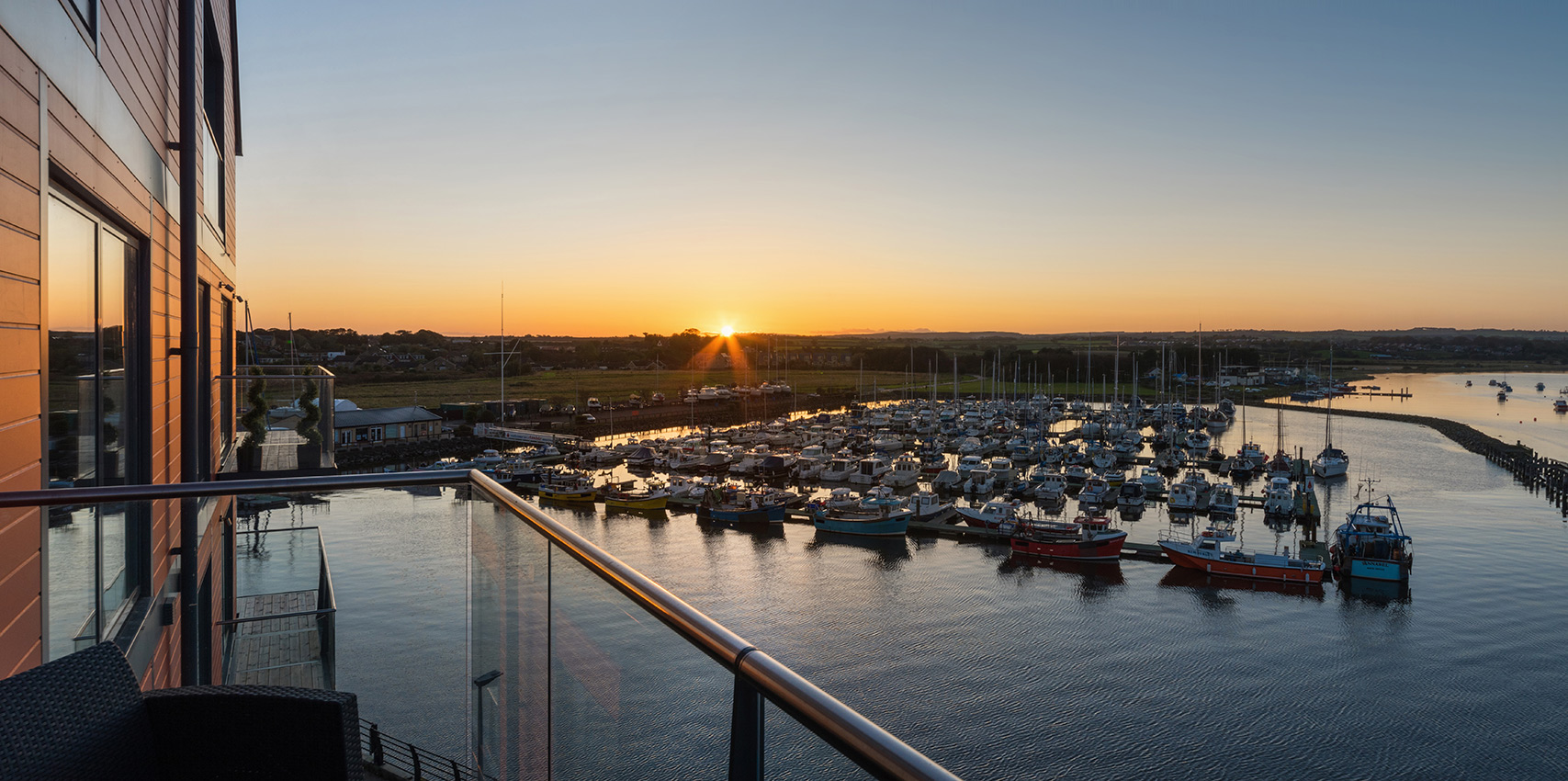 Balcony view over marina at sunset
