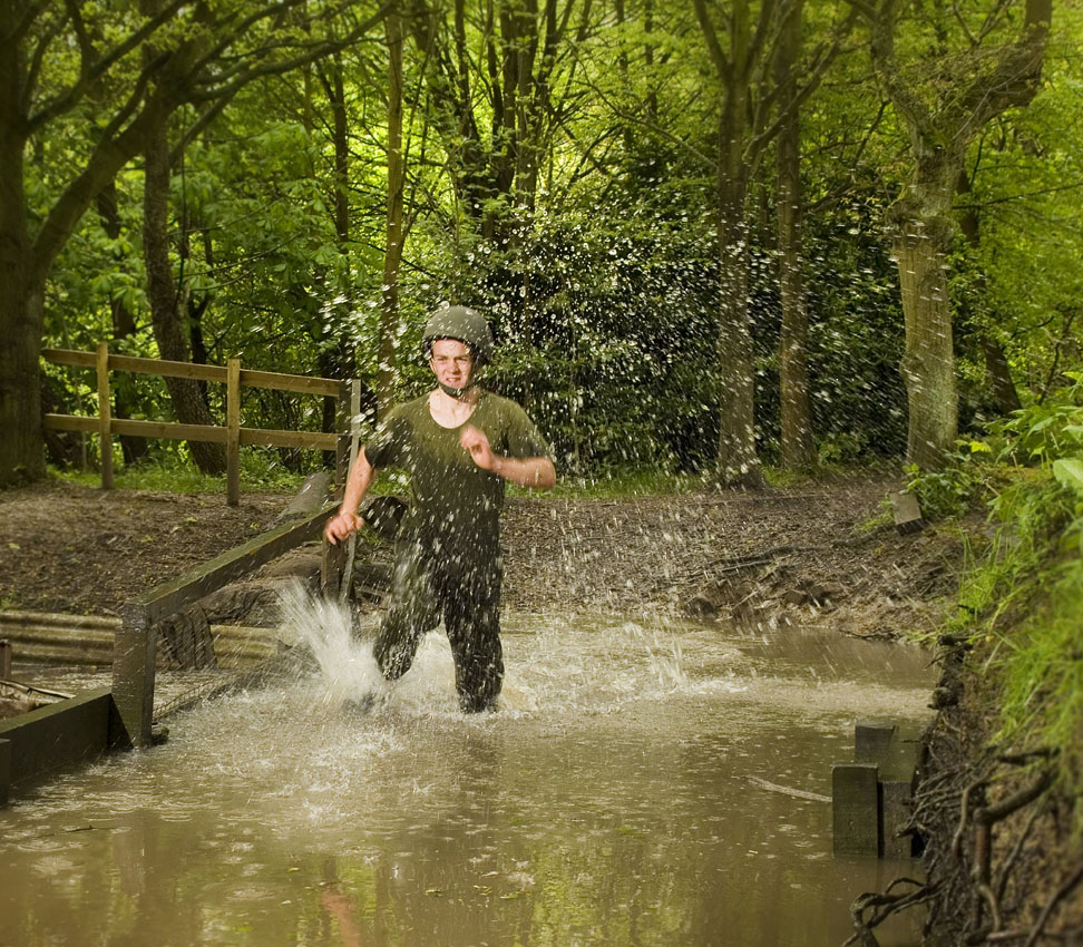 Action shot of a training and fitness session in a forest and water feature