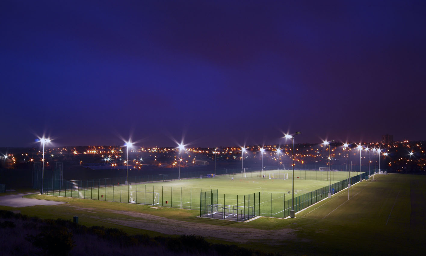 Flood lighting and football pitch at night