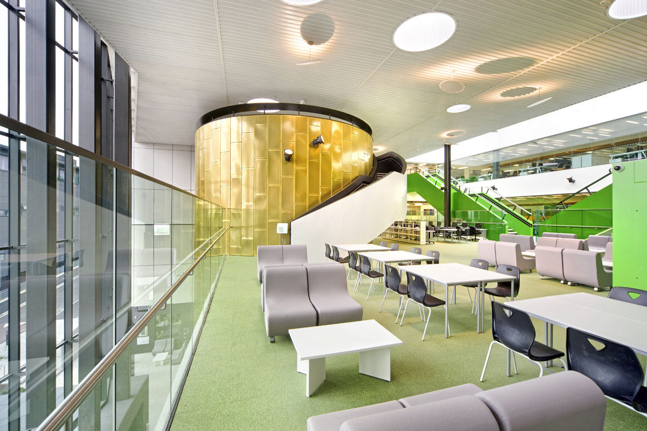 College building interior showing seating and lighting with large windows