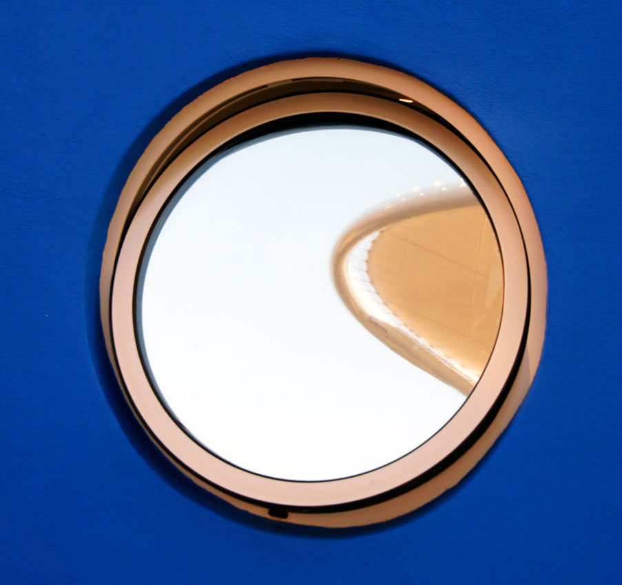 A detail of a round window in a blue wall