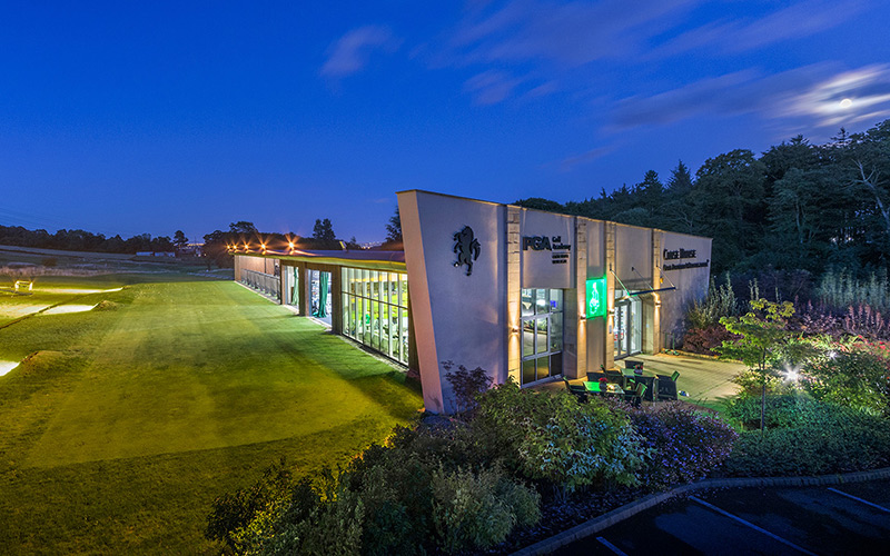 Exterior of a driving range at a golf academy at dusk
