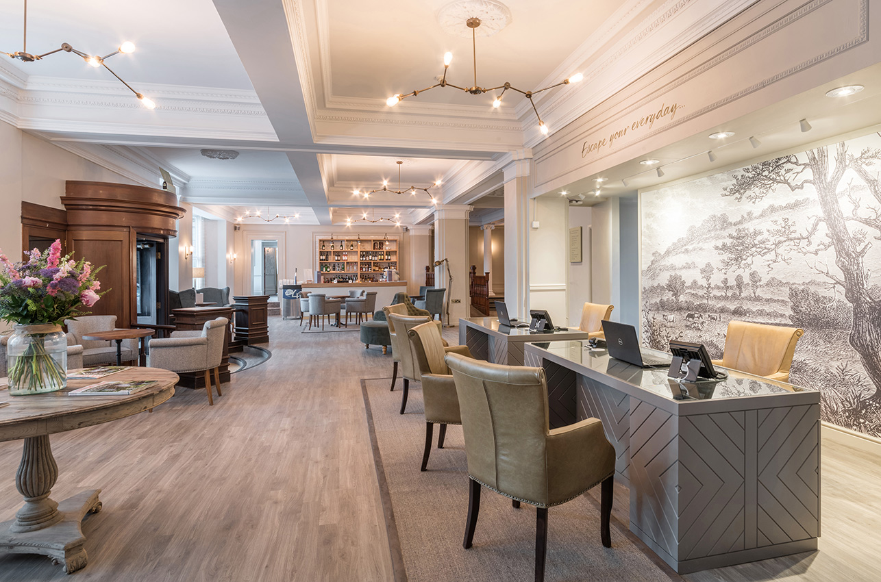 Hotel reception area with open plan design and wooden flooring