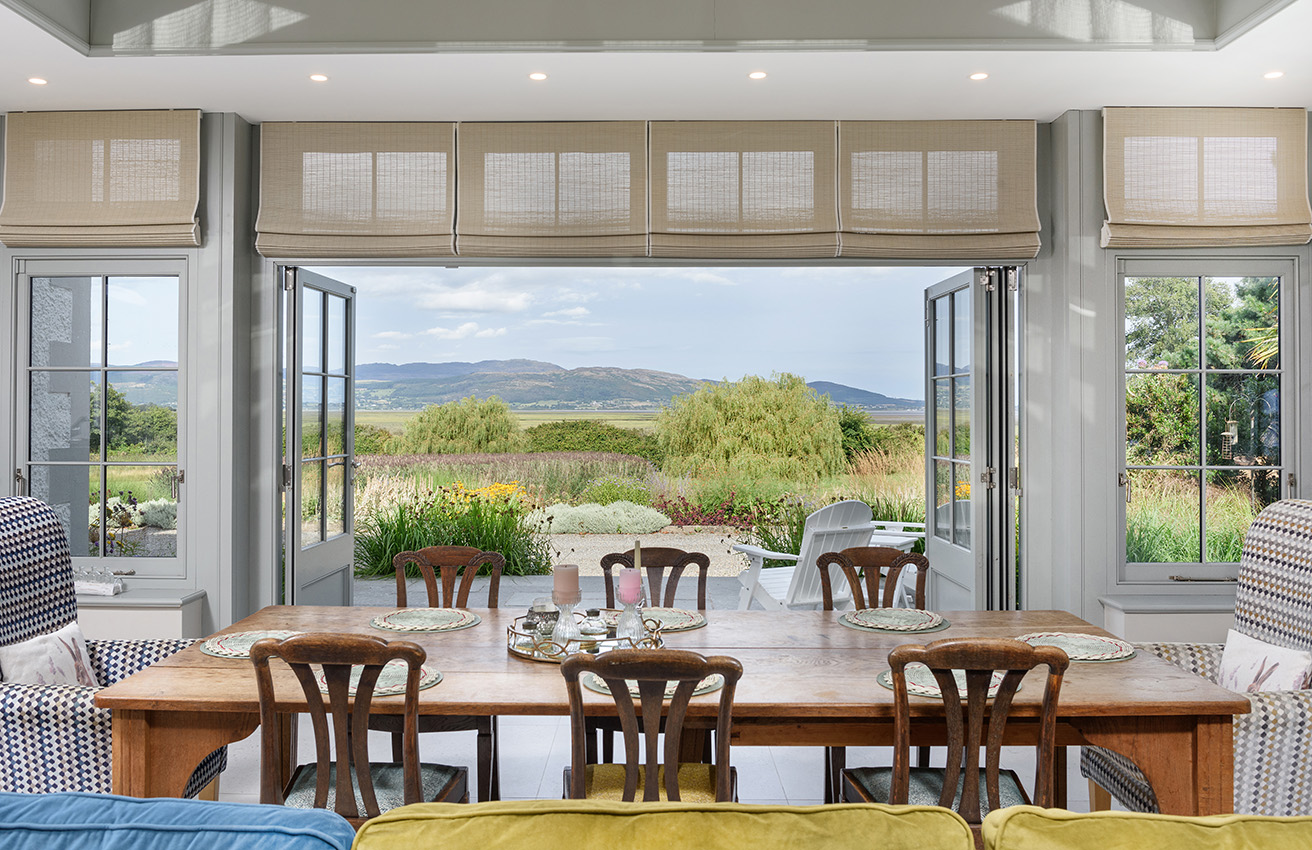Residential orangery interior looking towards the garden and hills in summer