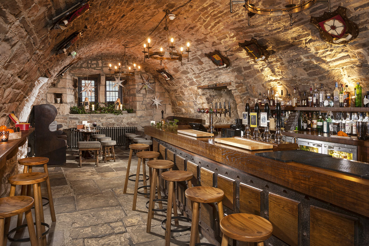 Hotel interior with arched stone walls and wooden furniture