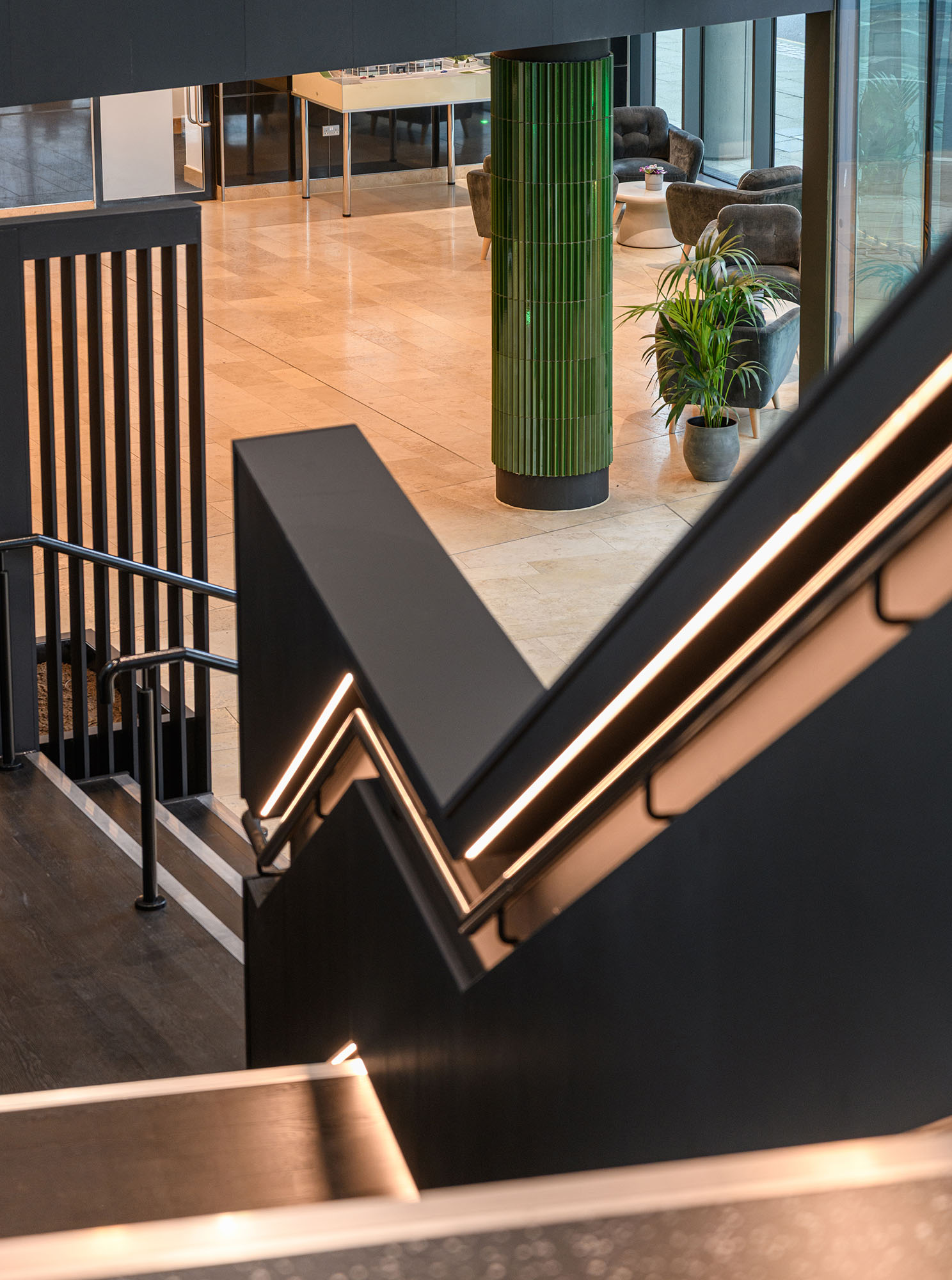 Office receprion and workplace with neon sign and tiled columns and floor