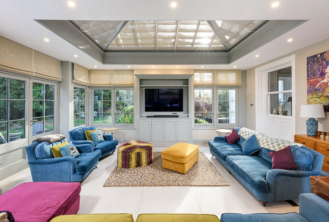 Orangery interior with colourful furniture and views to the garden