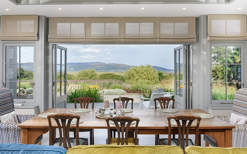Interior of an orengery with a view looking to gardens and mountains