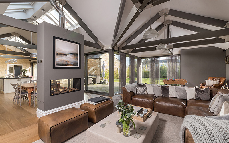 Interior of a residential property open plan with fireplace and beams