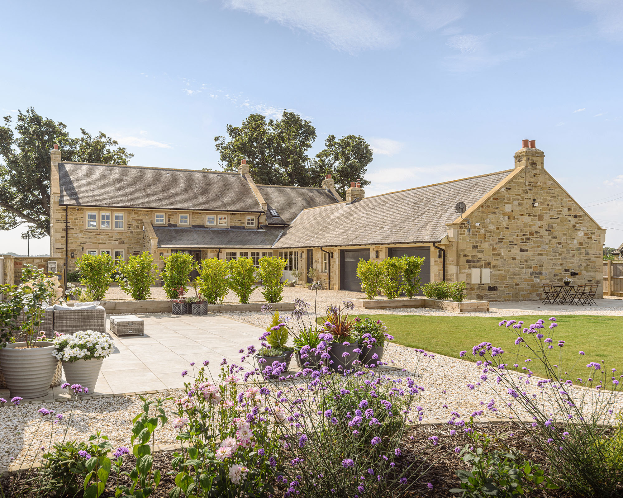 Residential property exterior photography shooting through garden planting in summer