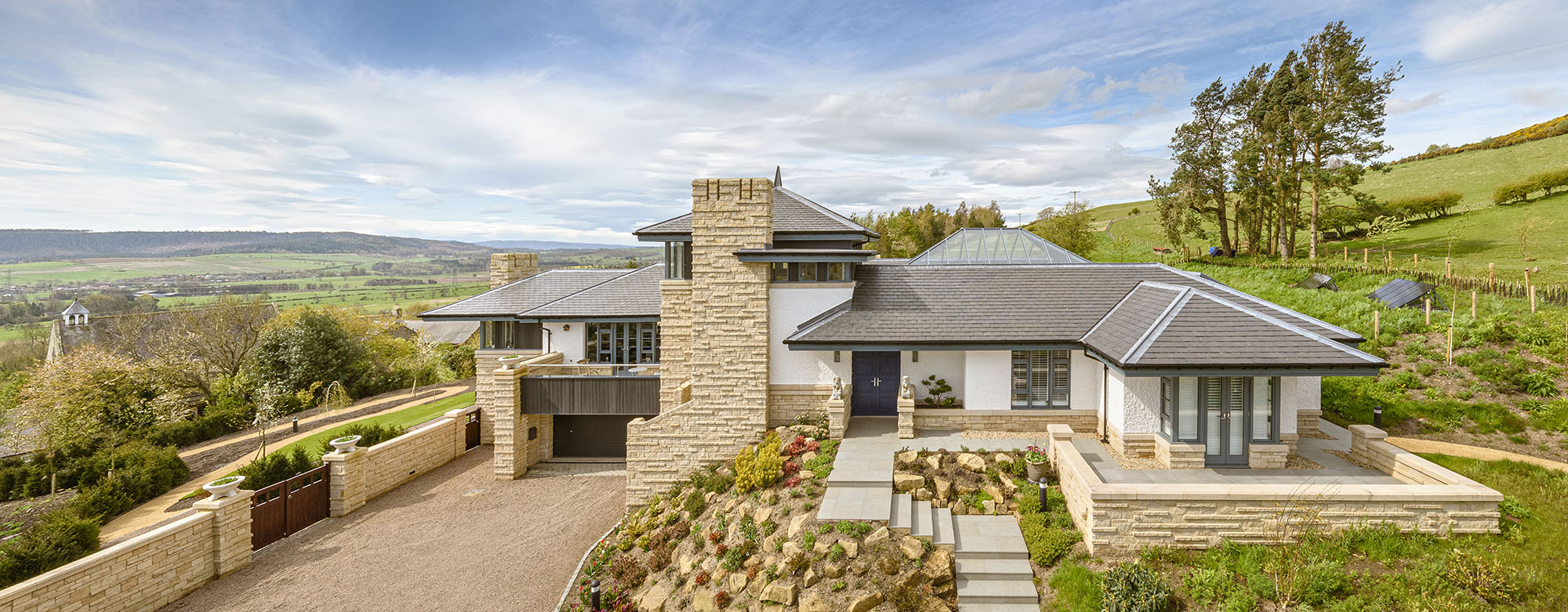 Architectural exterior of a residential property with countryside views