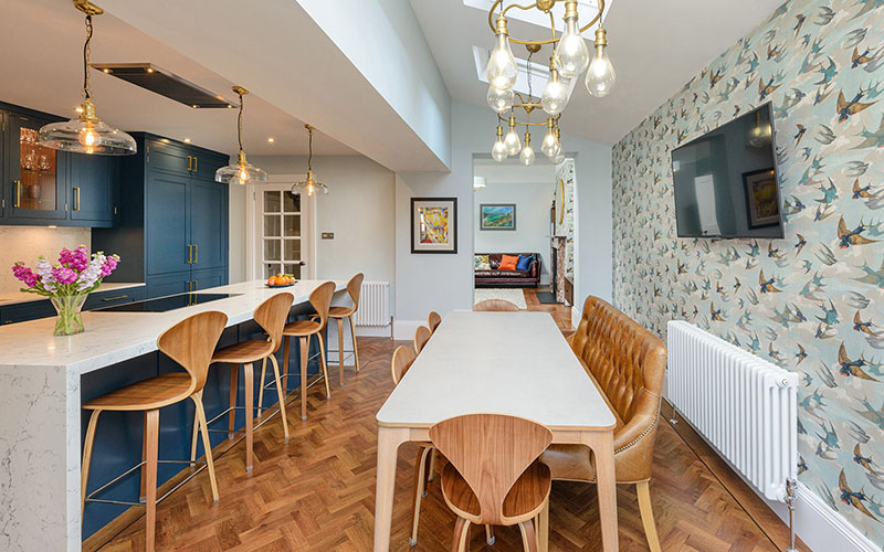 Interior of an open plan kitchen and diner with solid wood floor