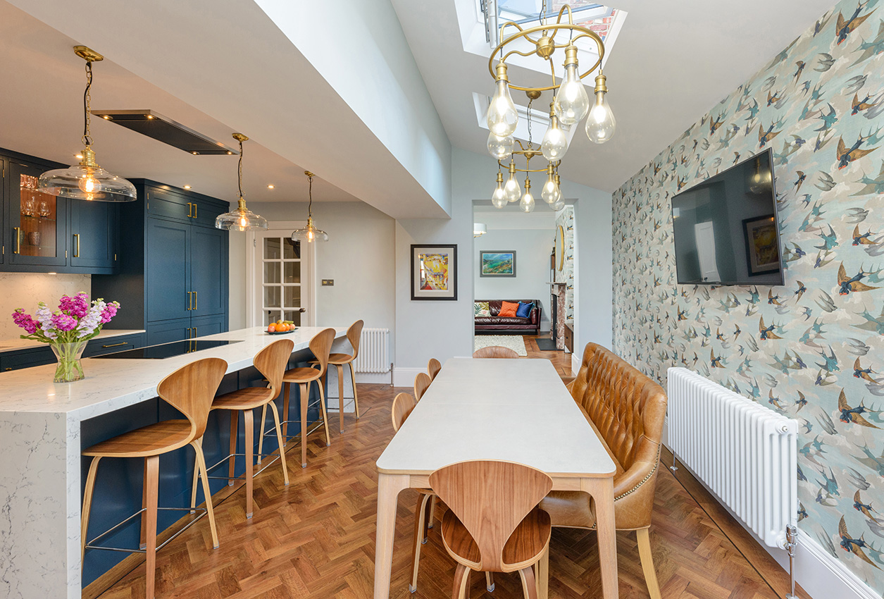 Interior of a kitchen and dining area with wooden floors